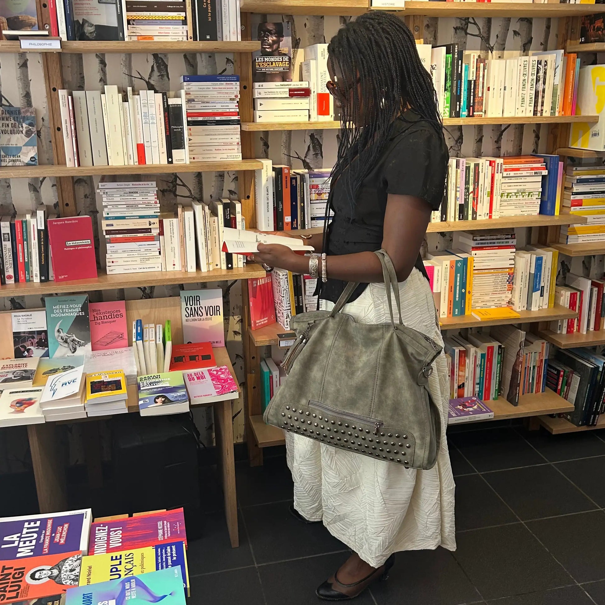 Woman carrying Beverly Bag champagne beige leather bookstore lifestyle
