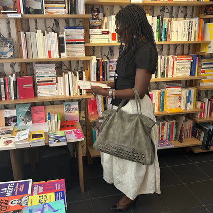 Woman carrying Beverly Bag champagne beige leather bookstore lifestyle
