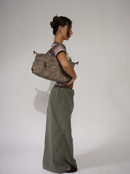 Woman holding LA Bag champagne beige leather maxi skirt outfit
